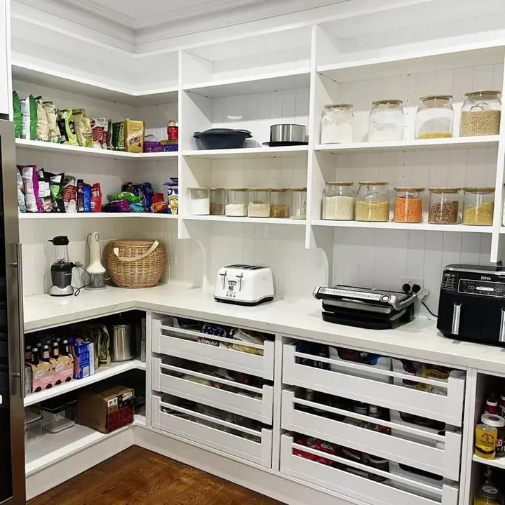 Walk-in pantry with open shelving and deep drawers