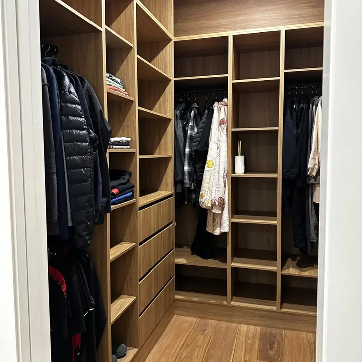 Walk-in robe with timber shelving and hanging rails